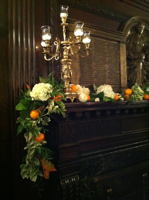 orange + magnolia leave garland for the mantle at a rehearsal dinner