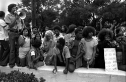 sinidentidades-blog:   Latin@s and Black people standing together to protest the murders of Black and Latin@ youth at the hands of the Austin Police Department. The men in the berets are Brown Berets, which was an activist group that came about during