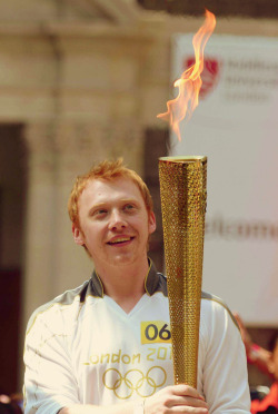 Rupert Grint carrying the Olympic Torch He’s