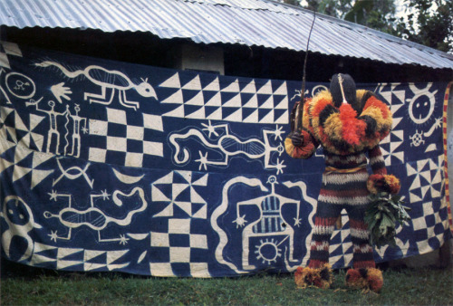 ukpuru:   NYANKPE POSING IN FRONT OF UKARA CLOTH. AKAMPKA.  — Elliott Leib and Renee Romano, 1984.