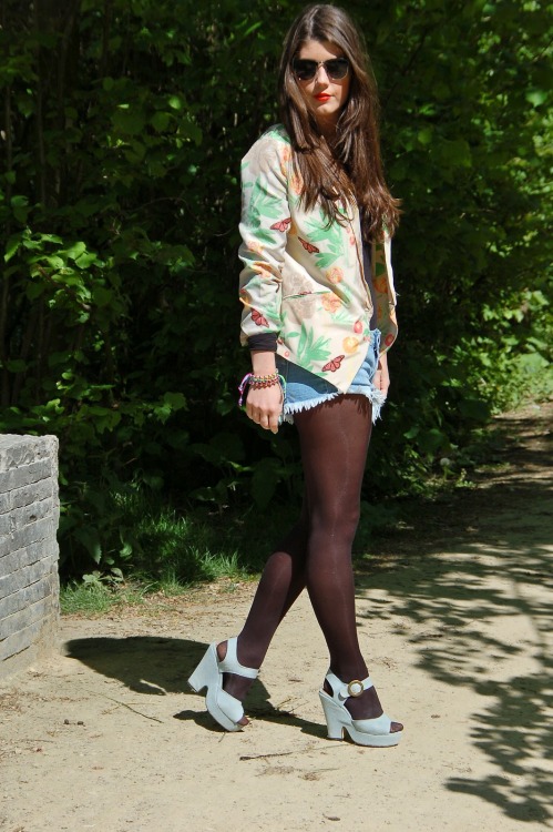 Black tights, denim shorts and light blue heels with nature print jacket