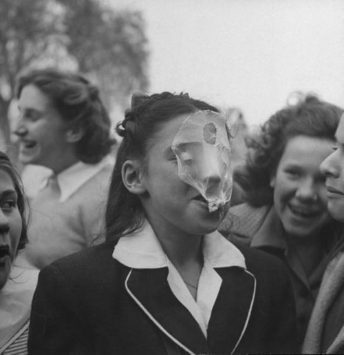  A young girl blowing a large bubble gum bubble (1946) by Bob Landry 