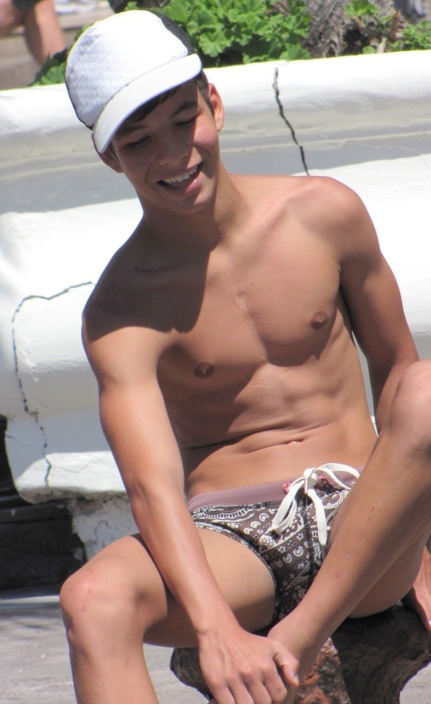 Cute smooth teen with Speedo and ball cap.