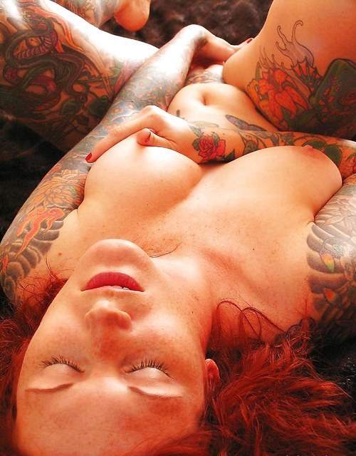 Porn photo Tattooed redhead touching herself. Hot!
