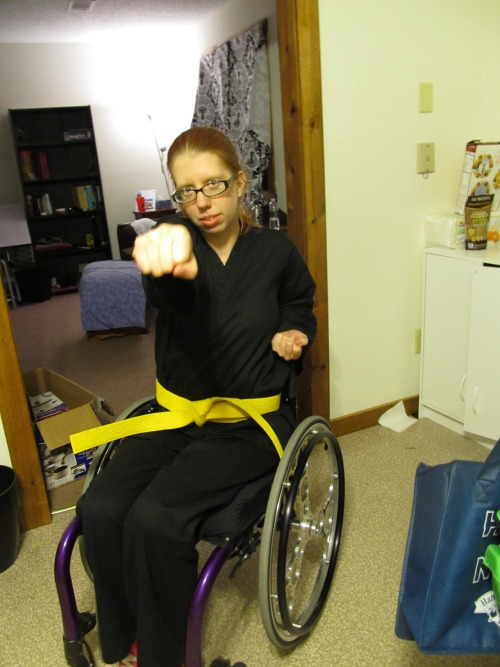 sasha-smithy:  Picture of me with my shiny new yellow belt sitting in full black gi uniform in my br