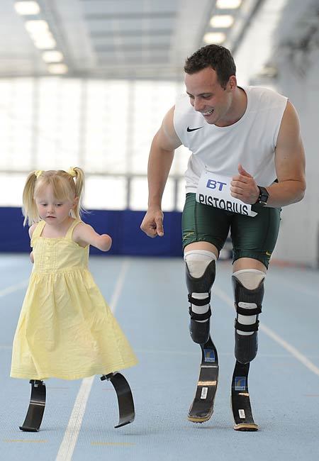 readyforsomefootball:  Oscar Pistorius runs with 5-year-old Ellie May Challis. Images taken from here, photographed by Andy Hooper. Find out more about Ellie May and her run with Oscar here.  