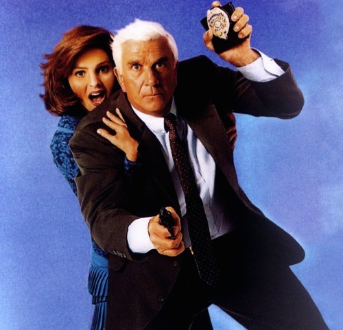 gunsandposes:Leslie Nielsen and Priscilla Presley doing the Naked Gun thing.