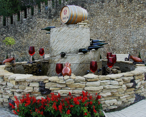 Red wine fountain outside the biggest wine cellars in the world in Milestii Mici, Moldova (by gomeni