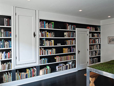 This loft has an upside down door. Very cool because that door is hiding the media center!