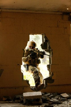 tyquinn8224:   victran:  Green Berets from the 20th Special Forces Group (Airborne) of the Army National Guard gain entry to a facility after creating hole with a sledge hammer while participating in a Special Forces Advanced Urban Combat (SFAUC) training