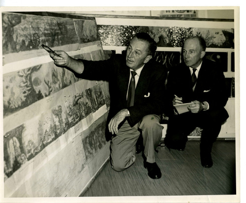 Walt Disney shows a reporter storyboards for the Submarine Voyage. 