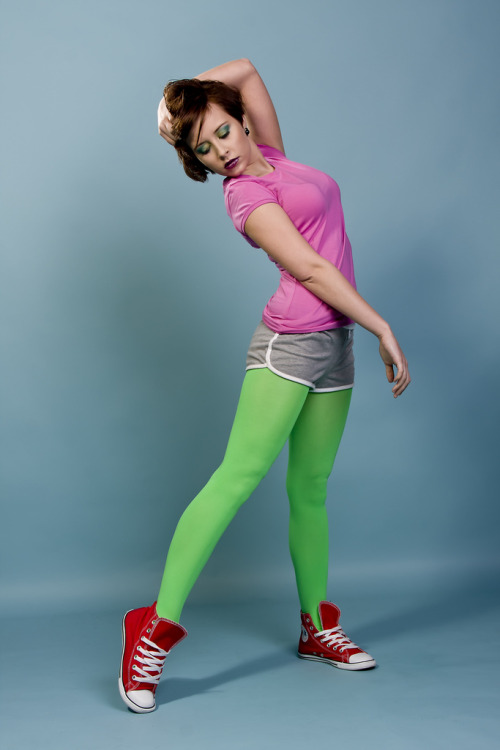 Flashy neon green tights with red All Stars, grey shorts and pink t-shirt