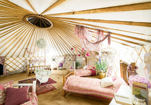 Beautiful beds and gorgeous fabrics in the flower yurt