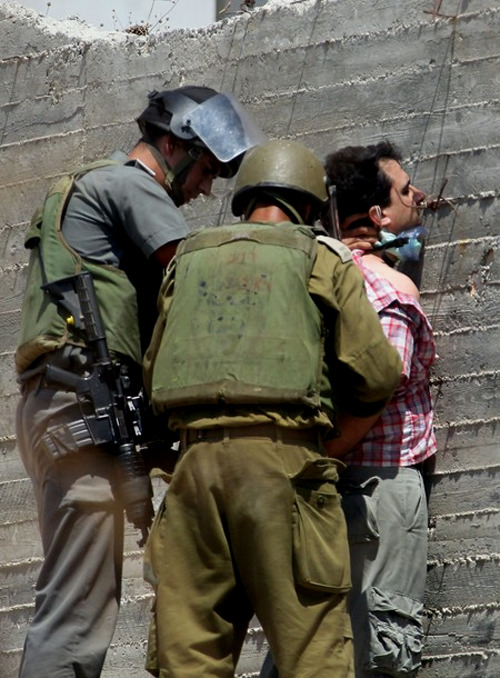 israelfacts:
“ Israeli soldiers arrest an international protestor for demonstrating against their theft of Palestinian land in the form of Jewish-only settlements, which violate international law, in the village of Kfar Qaddum in the West Bank,...