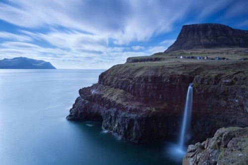 Photo and caption by Ken Bower  The village of Gásadalur and the island of Mykines in the background