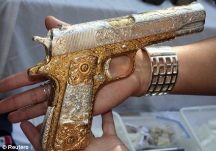 Redfining GaudyAnother tacky gun confiscated from Mexican drug lords, this time a Colt .38 super.