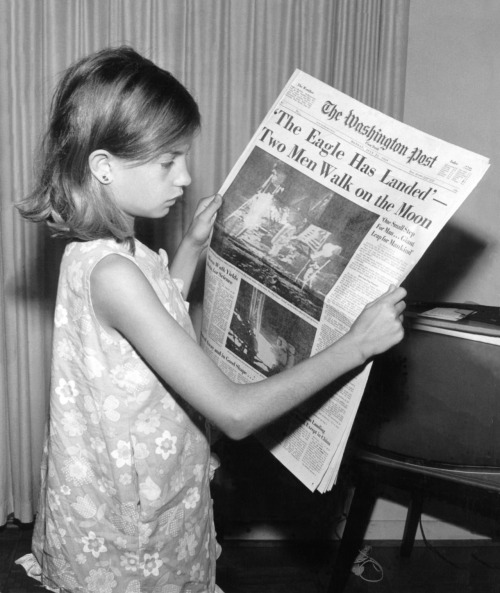 collective-history:A girl holds The Washington Post of Monday, July 21st 1969 stating ‘The Eagle Has
