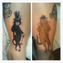 fuckyeahtattoos:  These are both of my cats done Edward Gorey style. I got the black one done first for my cat Mojo for his 10th birthday. I just got the second one for my cat Orange Cat. I love them so much. Done by Neil Worth at Forever Yours Tattoo