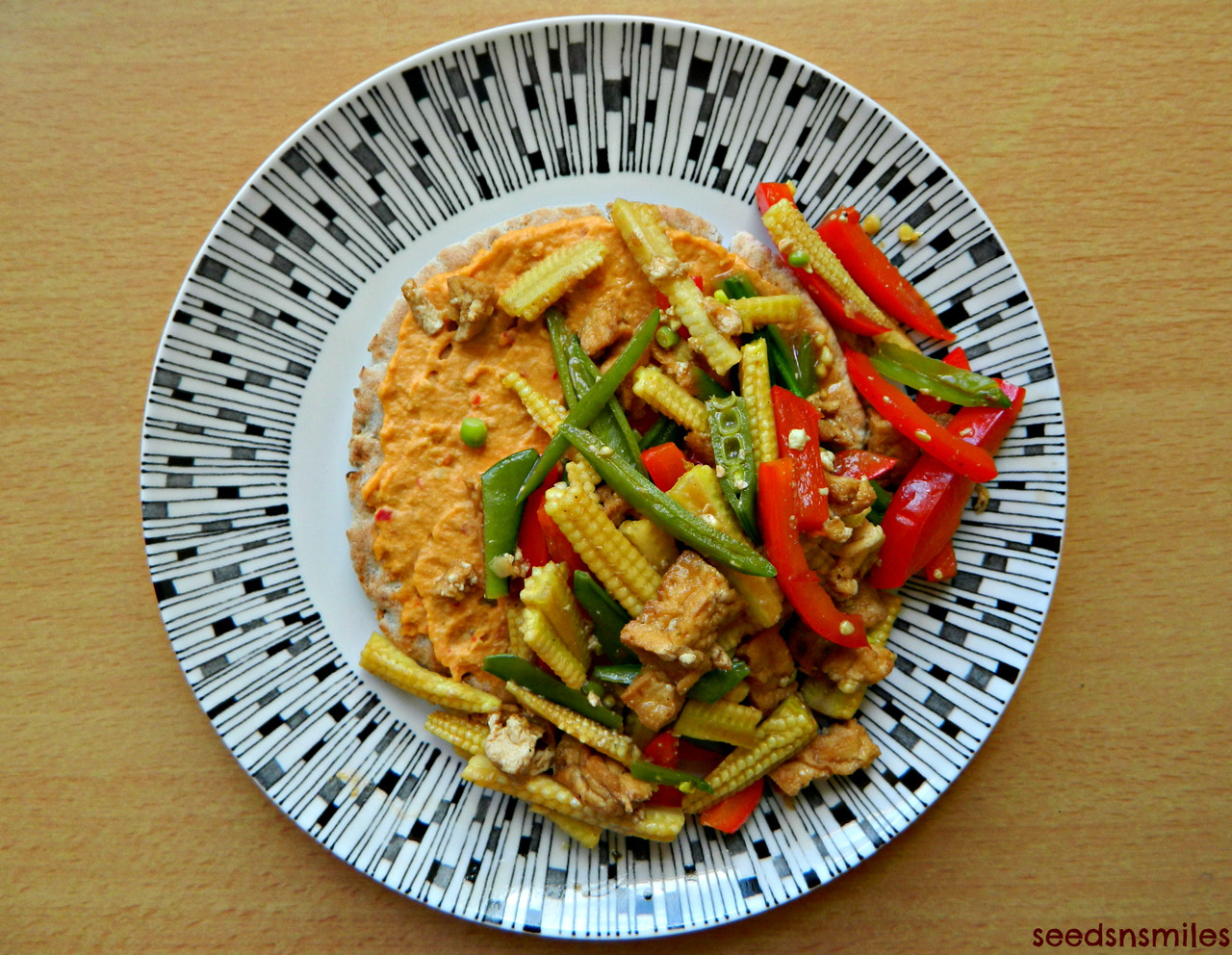 Toasted wholewheat, multi-seed pitta with piri-piri hummus and a tofu and vegetable stir fry.