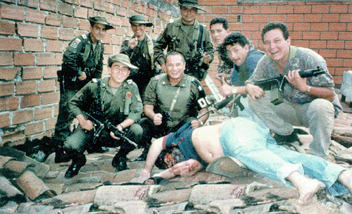 Colombian police stand over the body of drug lord Pablo Escobar, 1993.Head of the Medallin drug Cart