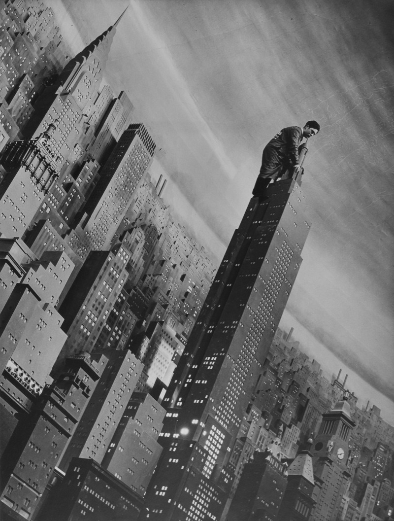 Margaret Bourke-White - Man working atop a 32 foot high replica of the Empire State