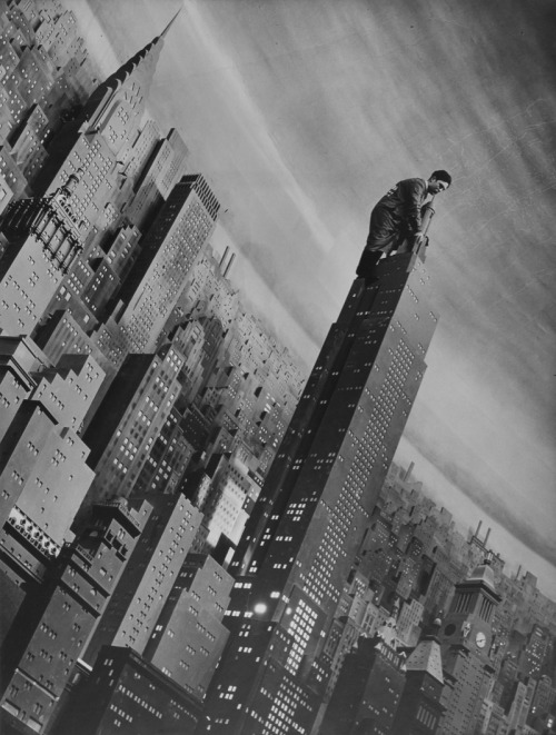 Margaret Bourke-White - Man working atop a 32 foot high replica of the Empire State Building, New York, 1939.