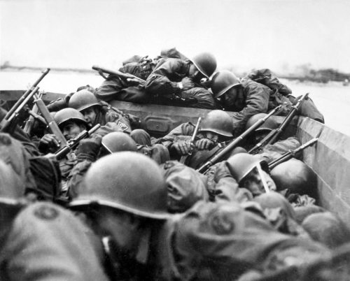 American soldiers try to take cover as they cross the Rhine River into Germany, March 1945.