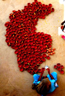 my-spirits-aroma:  An Indian woman paints earthen lamps on the outskirts of Jammu ahead of Hindu festival Diwali. Diwali, the festival of lights!! 