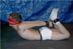 iluvboundboys:  do-not-open-til-christmas:  Of course, if you don’t wanna watch TV ….  Awesome hogtie! Nice and tight, arched back, cleave gag, nice little ass. This pic is as close to perfection as one comes! 