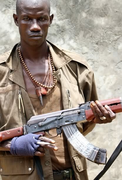 Smoke break XI…A rebel fighter on the Ivory Coast with a Chinese Type-56 II. These were the side-fol