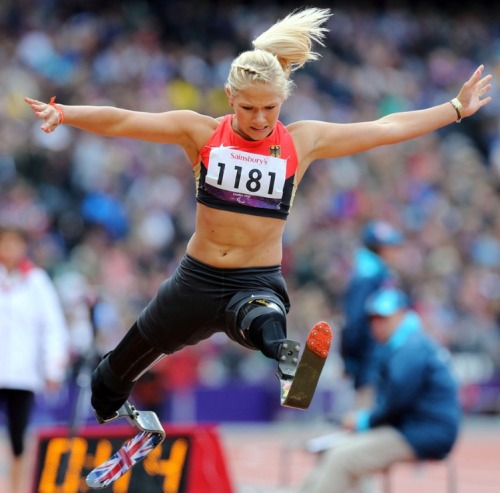 Vanessa Low jumping with British flag painted on her running blades.