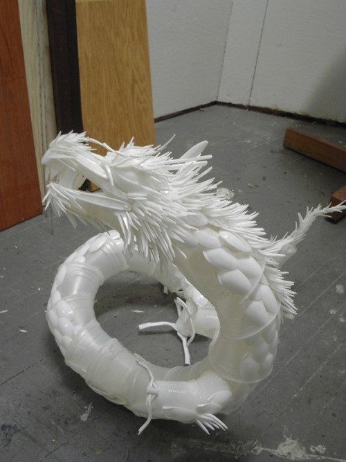 toxicneoncupcakes:A dragon made out of plastic utensils. 