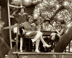 aubade:  “Washington. D.C. One of six National Photo glass negatives from 1921 labeled ‘Krazy Kat,’ showing a group of college-age kids painting and smoking in the yard of what seems to be a club or restaurant. Which has a treehouse.” 