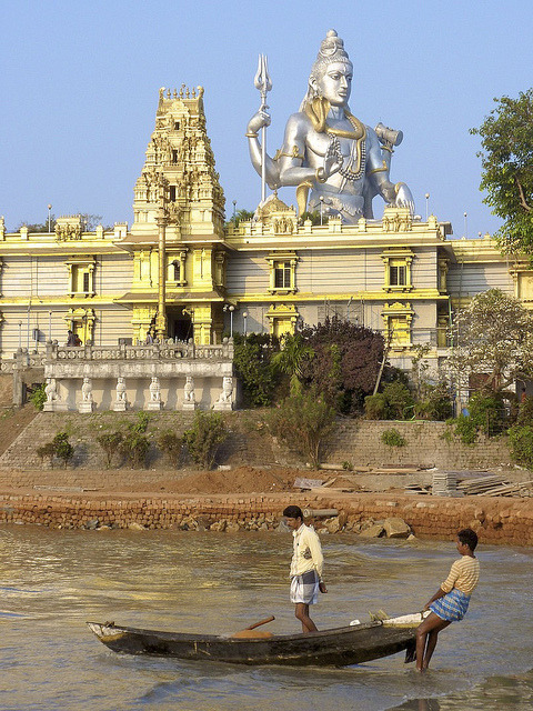 Fishermen taking out under the watchful eye of Shiva in Murudeshwara, Karnataka, India (by Steve Hog