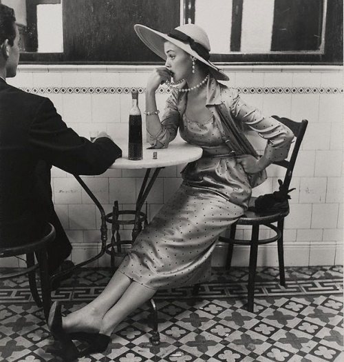 chagak:  This famous impromptu photograph of model Jean Patchett chewing on her pearls, waiting pensively in a café in Lima, Peru was taken in 1948, but appeared in the 15 February 1949 issue of Vogue. It was part of a photo-spread called “Flying