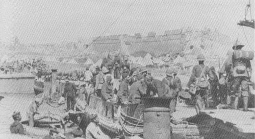 British troops unload in the shadows of the ruined fort of Sedd-al-Bahr.