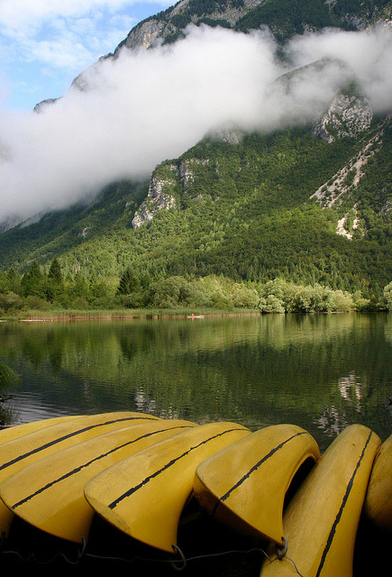 Yellow canoes on the shores of Lake Bohinj, Slovenia (by flatworldsedge).