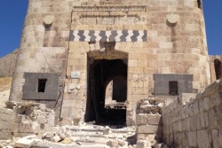 archaeology:  Syria’s Looted Past: How Ancient Artifacts Are Being Traded for Guns Photo: The badly damaged outer gate of Aleppo’s Citadel after government opponents try to blast their way into the ancient fortress.  Abu Khaled knows the worth of