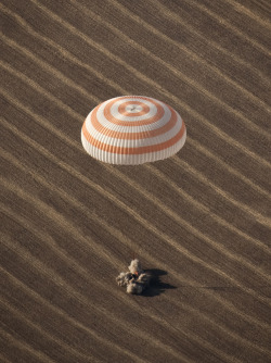 Expedition 20 Landing (200910110010HQ) The Soyuz TMA-14 spacecraft is seen as it lands with Expedition 20 Commander Gennady Padalka, Flight Engineer Michael Barratt, and spaceflight participant Guy Laliberté near the town of Arkalyk, Kazakhstan on Sunday,