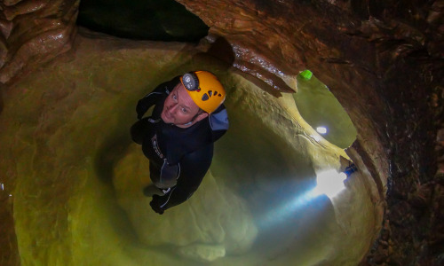 Mike Fincke standing in a pond in a cave