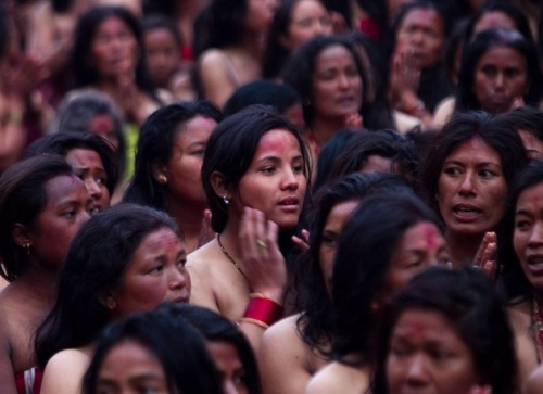 delucazade: Women pray before taking a mass holy bath in the Bagmati river on Jan. 23, 2012. Navesh 