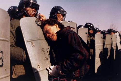 keepyourdreams4ever: South Korea, 1987 Anthony Suau A mother clings to a riot policeman’s shield at a polling station. Her son was one of thousands of demonstrators arrested because they tried to prove that the presidential election on December 15,