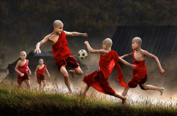 insomnicdaydream:  Monks playing football. (by Chan Kwok Hung) 