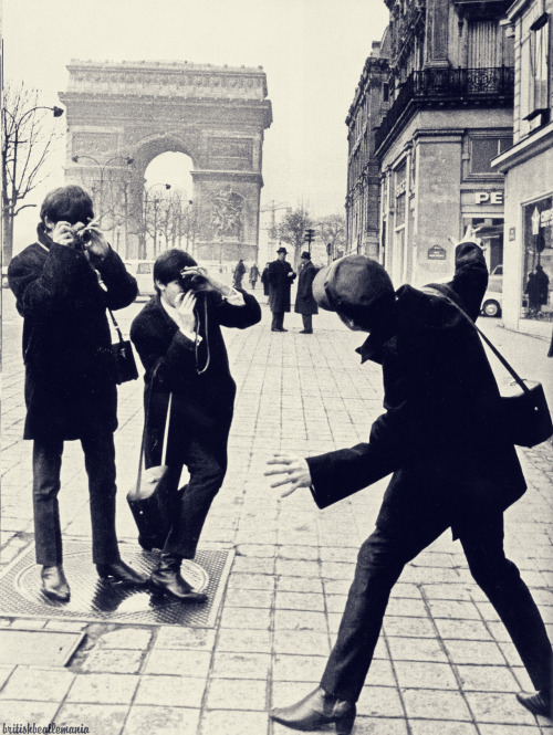 George and Paul taking photos of John in Paris, 1964.