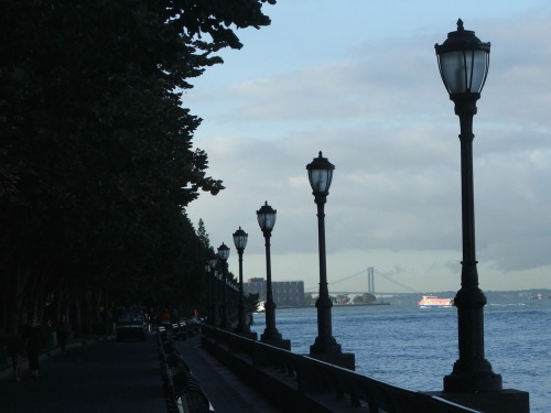 Hudson River Park in lower Manhattan with the Verrazano Narrows Bridge in the distance. The park is 