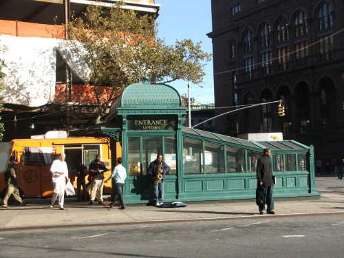 The Astor Place subway station with its distinctive glass and steel entrance. This is a cast-iron re