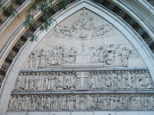 Detail of a bas-relief above the entrance to the Church of the Blessed Sacrament is tucked away on W