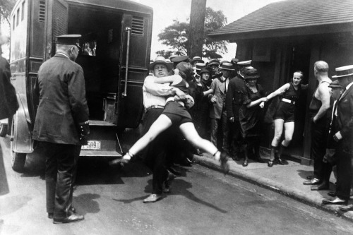 Women being arrested for wearing bathing suits that were too revealing; Chicago, 1922.
