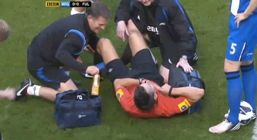 Premier League referee Lee Probert finds himself in the middle of a crunching tackle between Steve Sidwell and Gary Caldwell. 