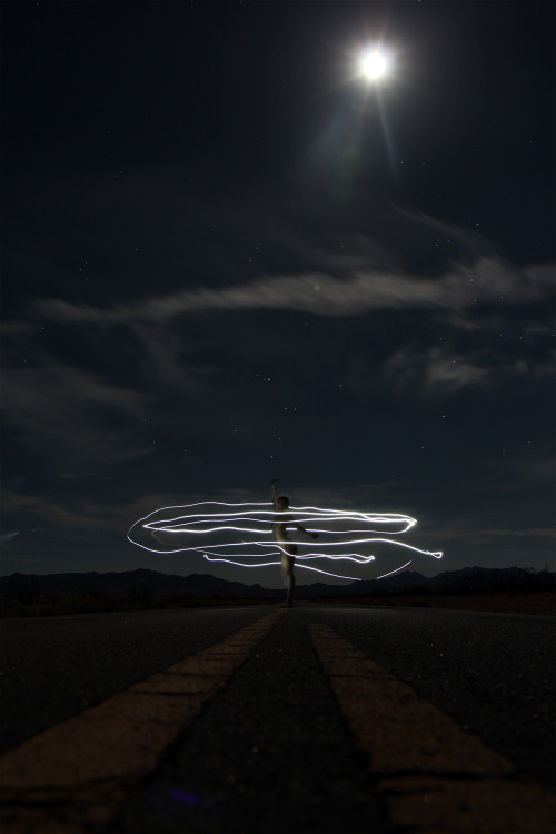 This is me in the desert, I miss america so much. It was such a magical experience. We lay on the road and looked at the stars. galaxiesrotate:  valley of fire 2 am, full moon, neveda desert (2012) 